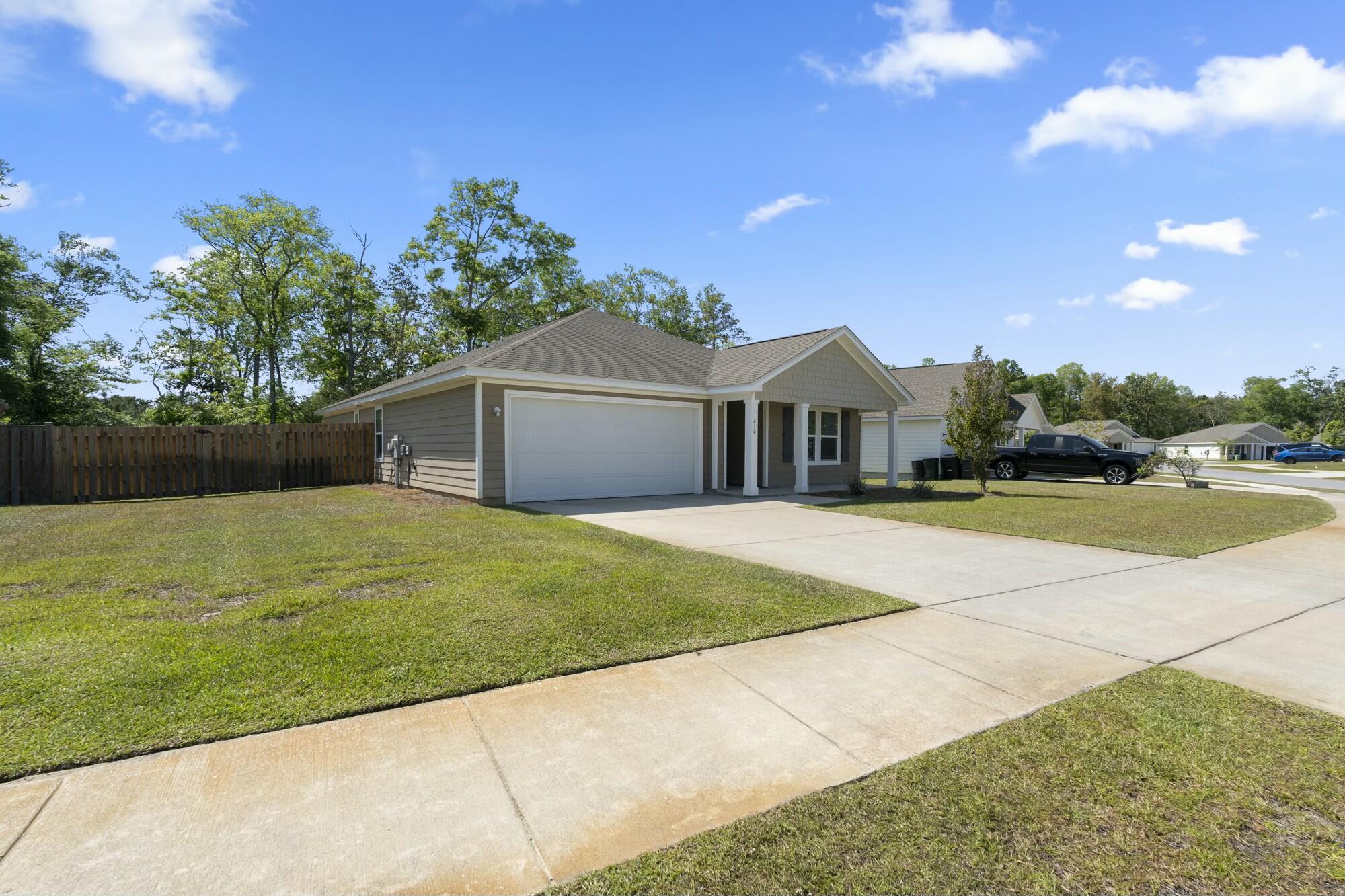 610 Riverwalk Circle Freeport, FL 32439 - Photo 4 of 50 a house with garden in front of it