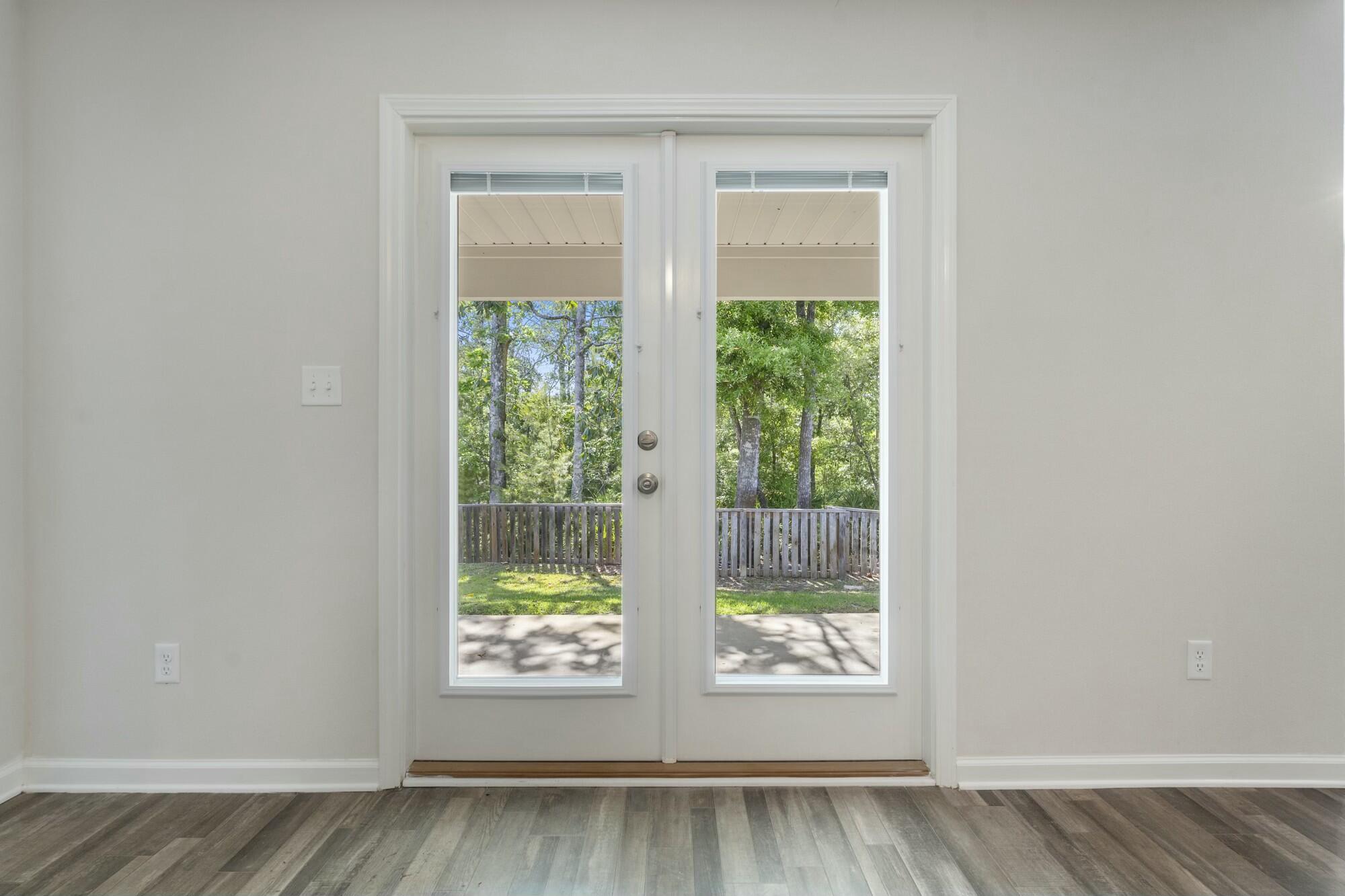 610 Riverwalk Circle Freeport, FL 32439 - Photo 45 of 50 a view of an empty room with wooden floor and a window