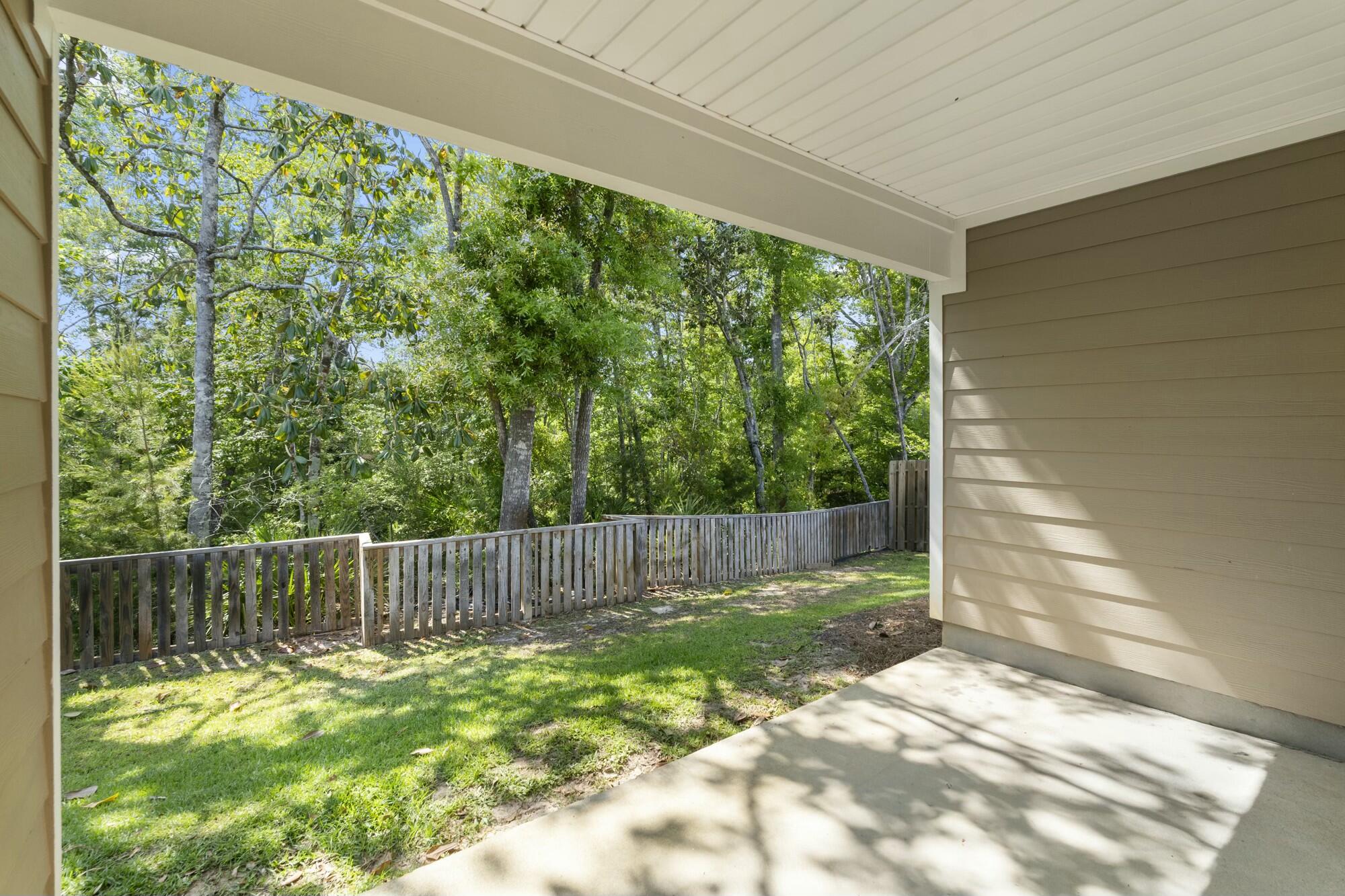 610 Riverwalk Circle Freeport, FL 32439 - Photo 48 of 50 a view of a backyard with plants and wooden fence