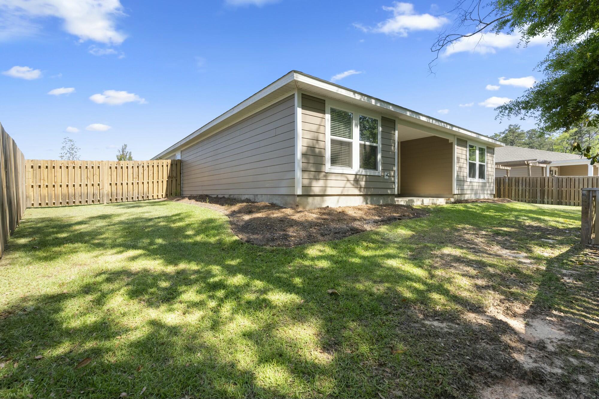 610 Riverwalk Circle Freeport, FL 32439 - Photo 50 of 50 a front view of a house with a yard