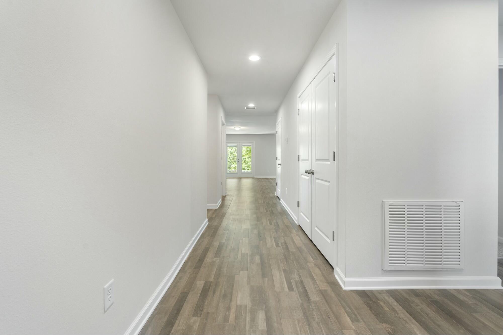 610 Riverwalk Circle Freeport, FL 32439 - Photo 7 of 50 a view of a hallway with wooden floor