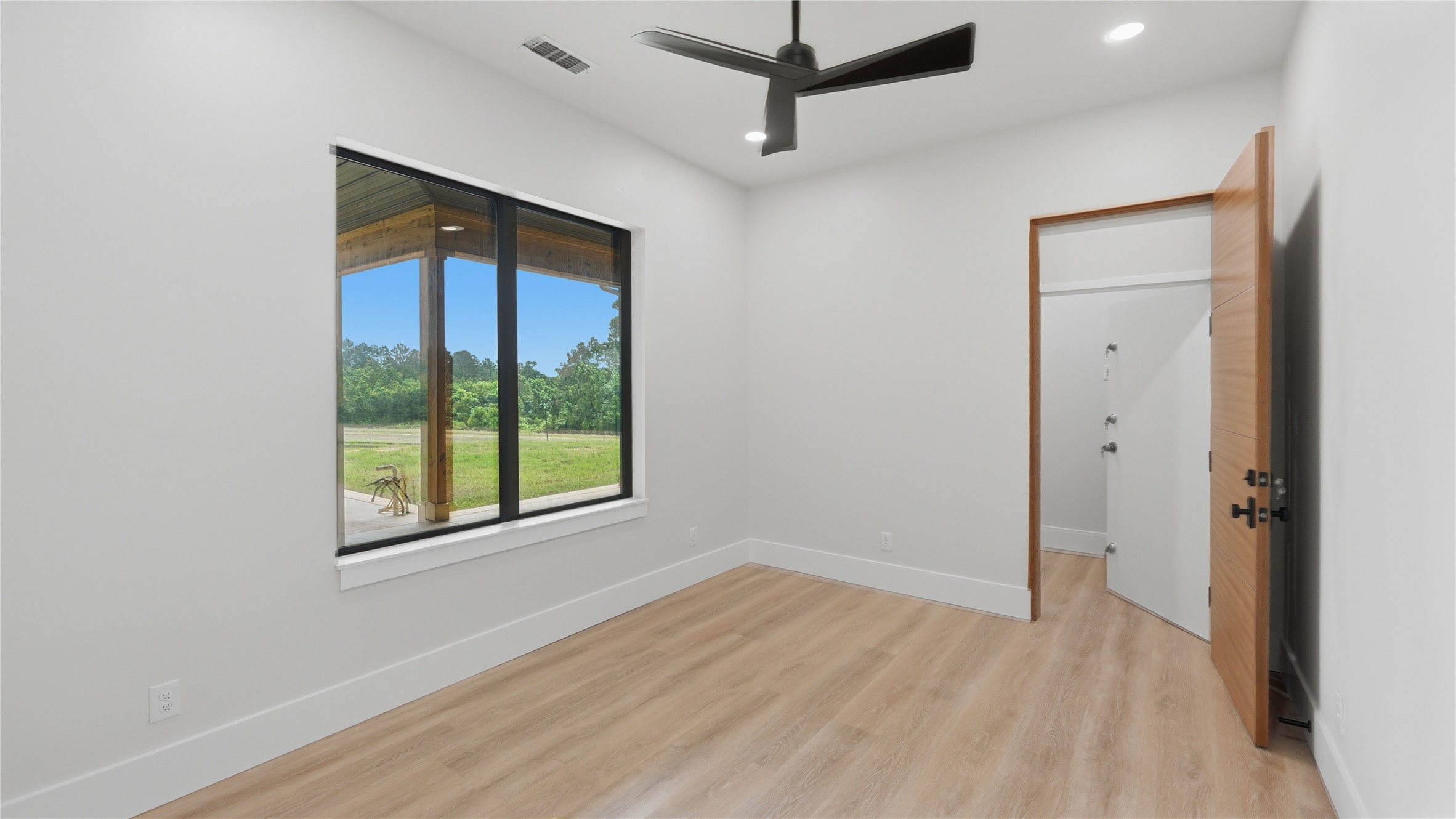 447 County Road 2211 Rusk, TX 75785 - Photo 46 of 50 wooden floor in an empty room with a window