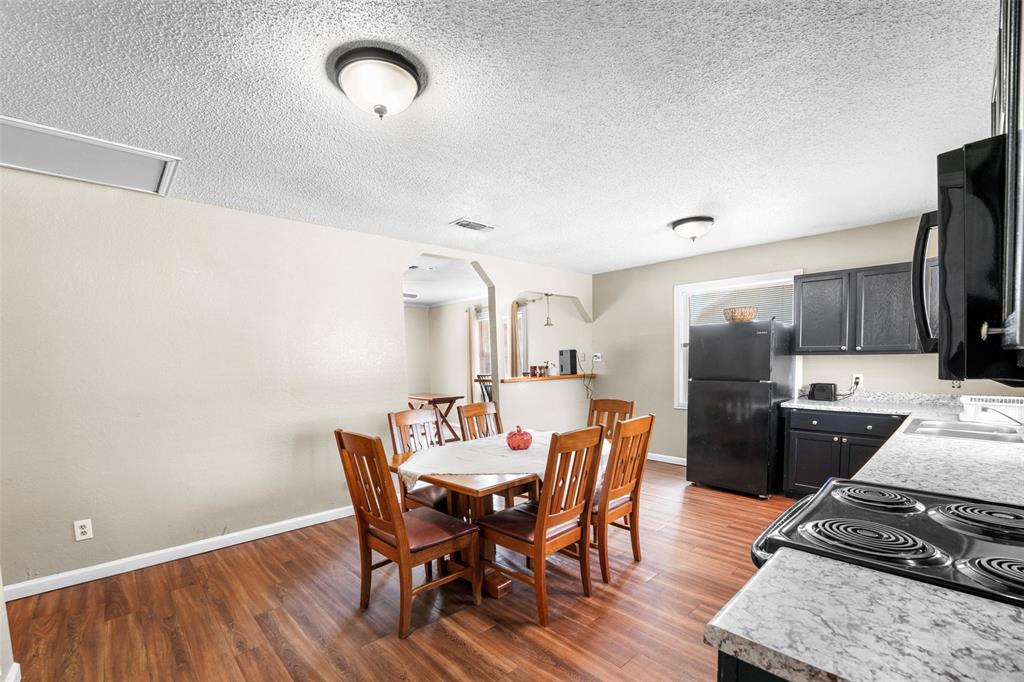 1145 Jefferson Road Paris, TX 75460 - Photo 7 of 17 a view of a dining room with furniture and a chandelier