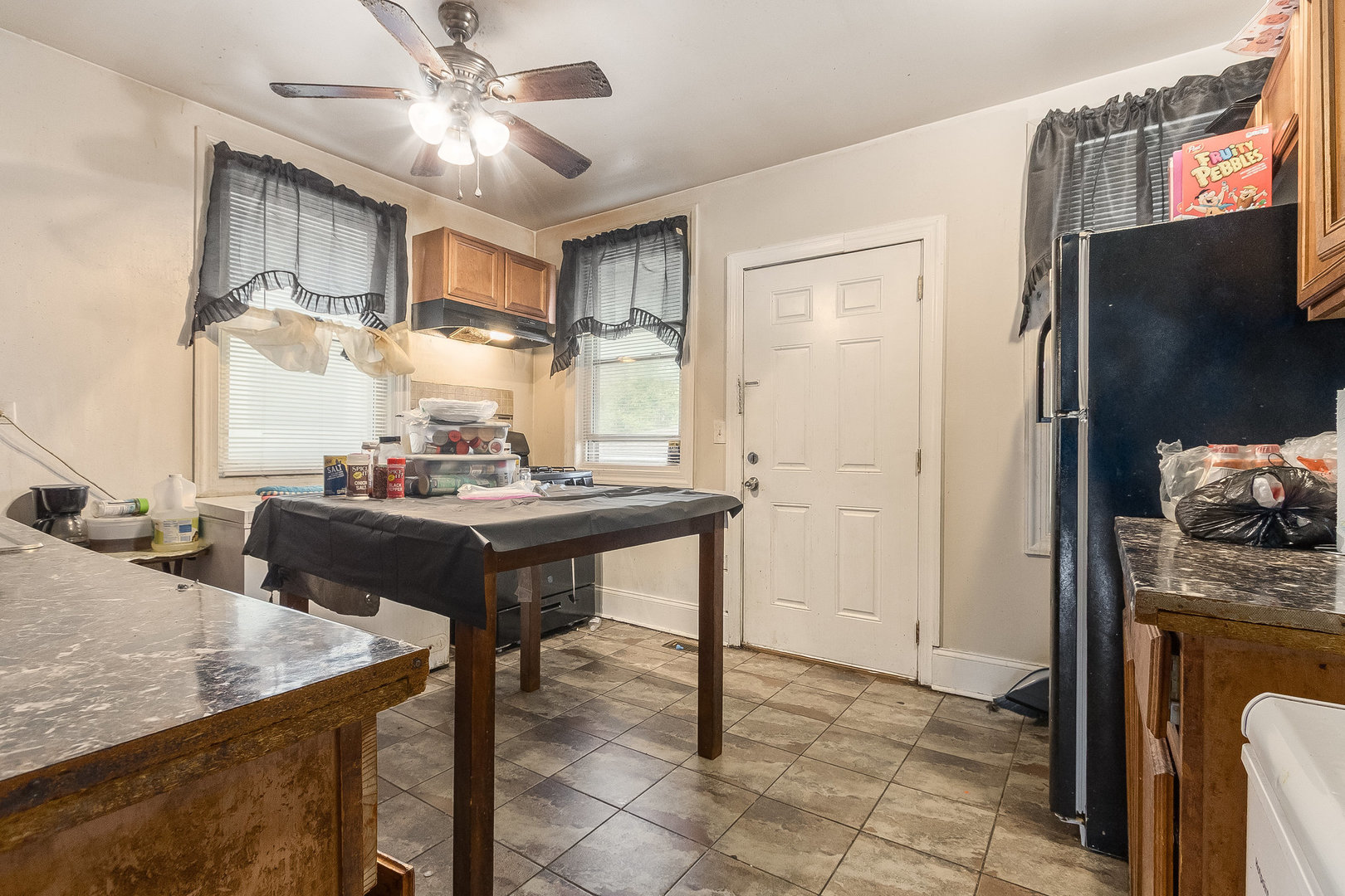 8011 South Ada Street Chicago, IL 60620 - Photo 4 of 15 a view of kitchen island with stainless steel appliances wooden floor dining table and chairs