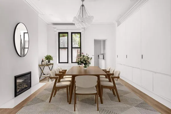 a dining room with furniture a chandelier and wooden floor