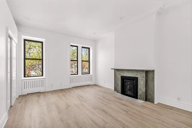 a bedroom with furniture and a fireplace