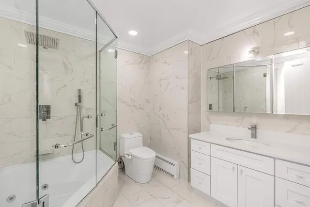 an empty room with windows and fireplace