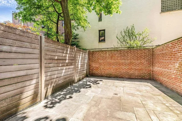 a view of a backyard with sitting area