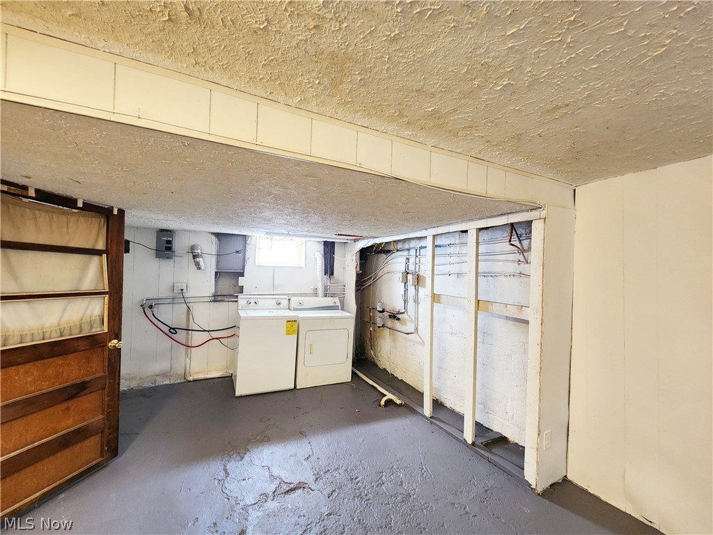 30 West Wilbeth Road, Unit A Akron, OH 44301 - Photo 13 of 16 Basement with washing machine and clothes dryer and a textured ceiling