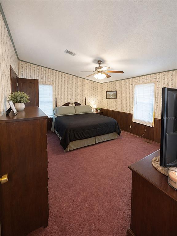 2665 Absher Road St. Cloud, FL 34771 - Photo 21 of 27 a bedroom with a bed and wooden floor