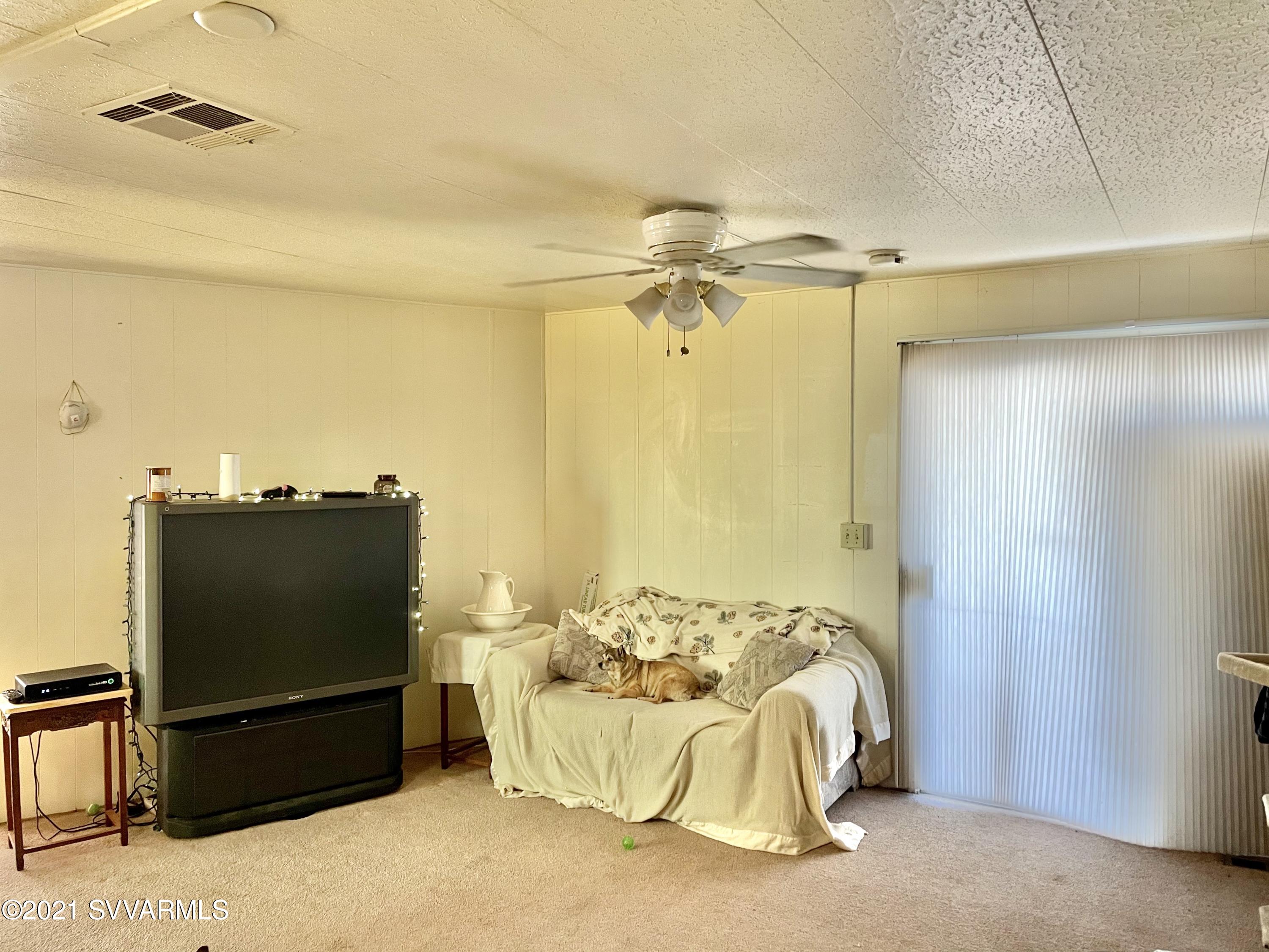 4905 Ho Hum Trail Rimrock, AZ 86335 - Photo 11 of 16 a bedroom with a bed and a flat screen tv