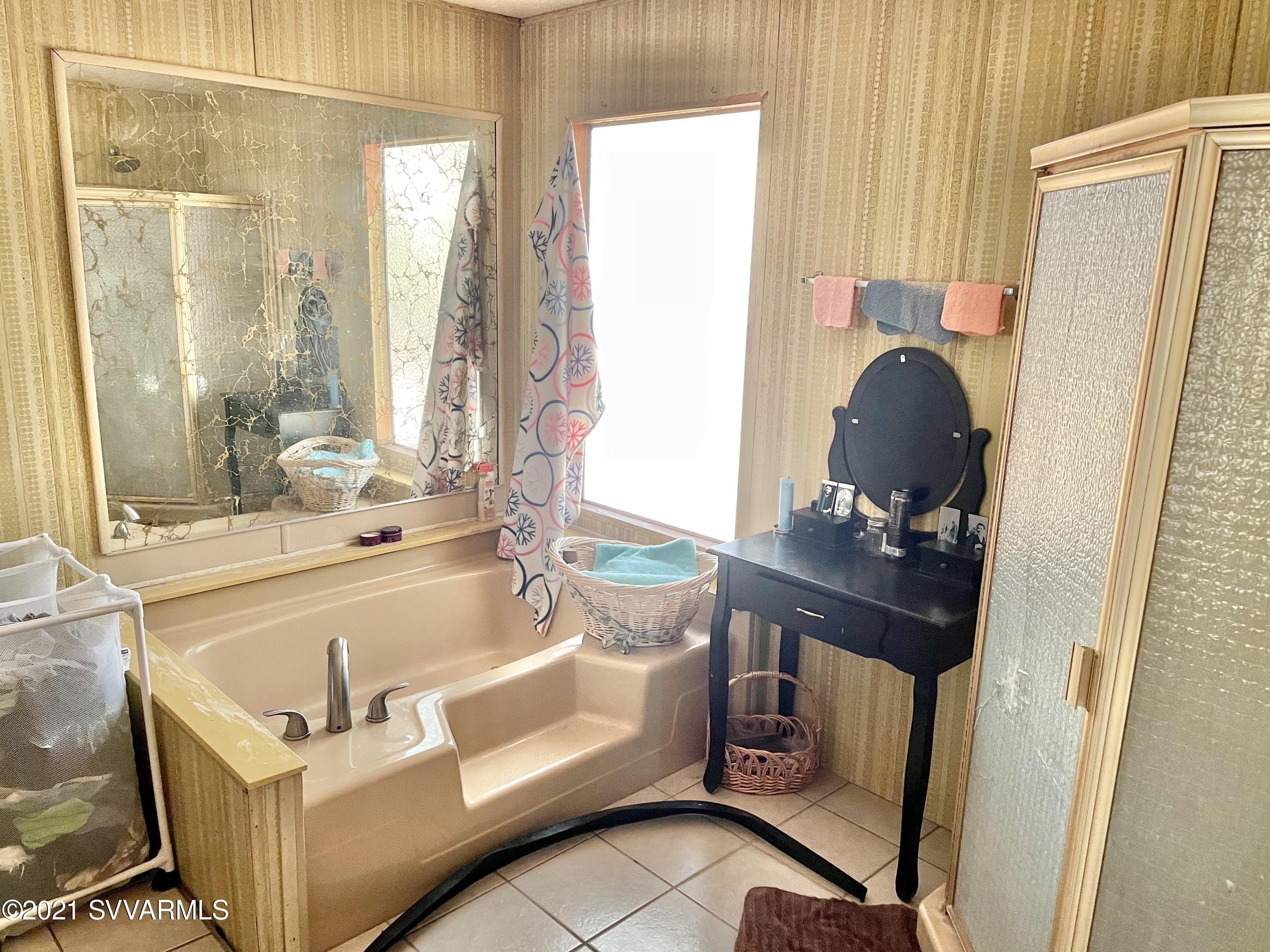 4905 Ho Hum Trail Rimrock, AZ 86335 - Photo 12 of 16 a bathroom with a tub sink and mirror