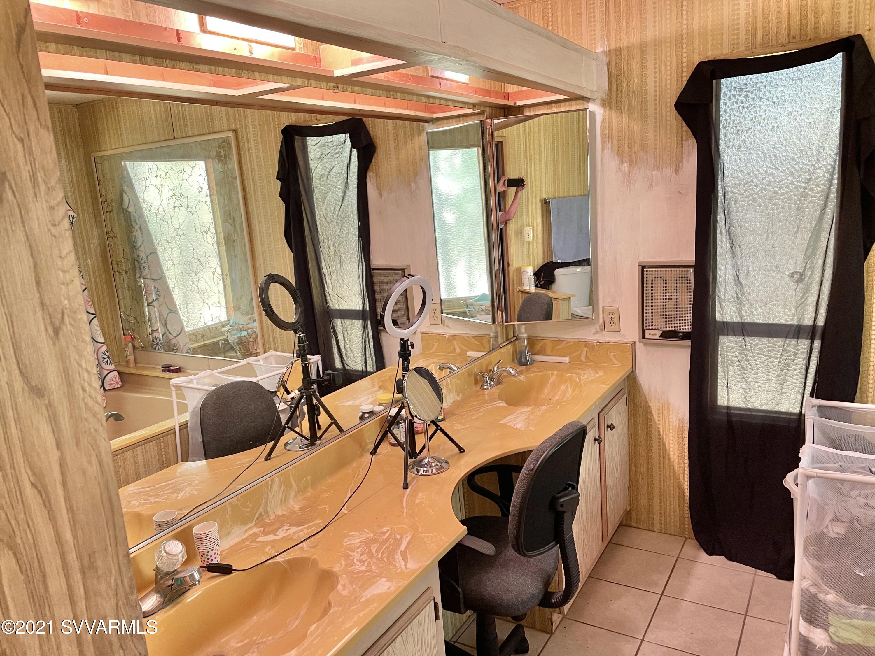 4905 Ho Hum Trail Rimrock, AZ 86335 - Photo 13 of 16 a en suite bathroom with a double vanity sink and a mirror