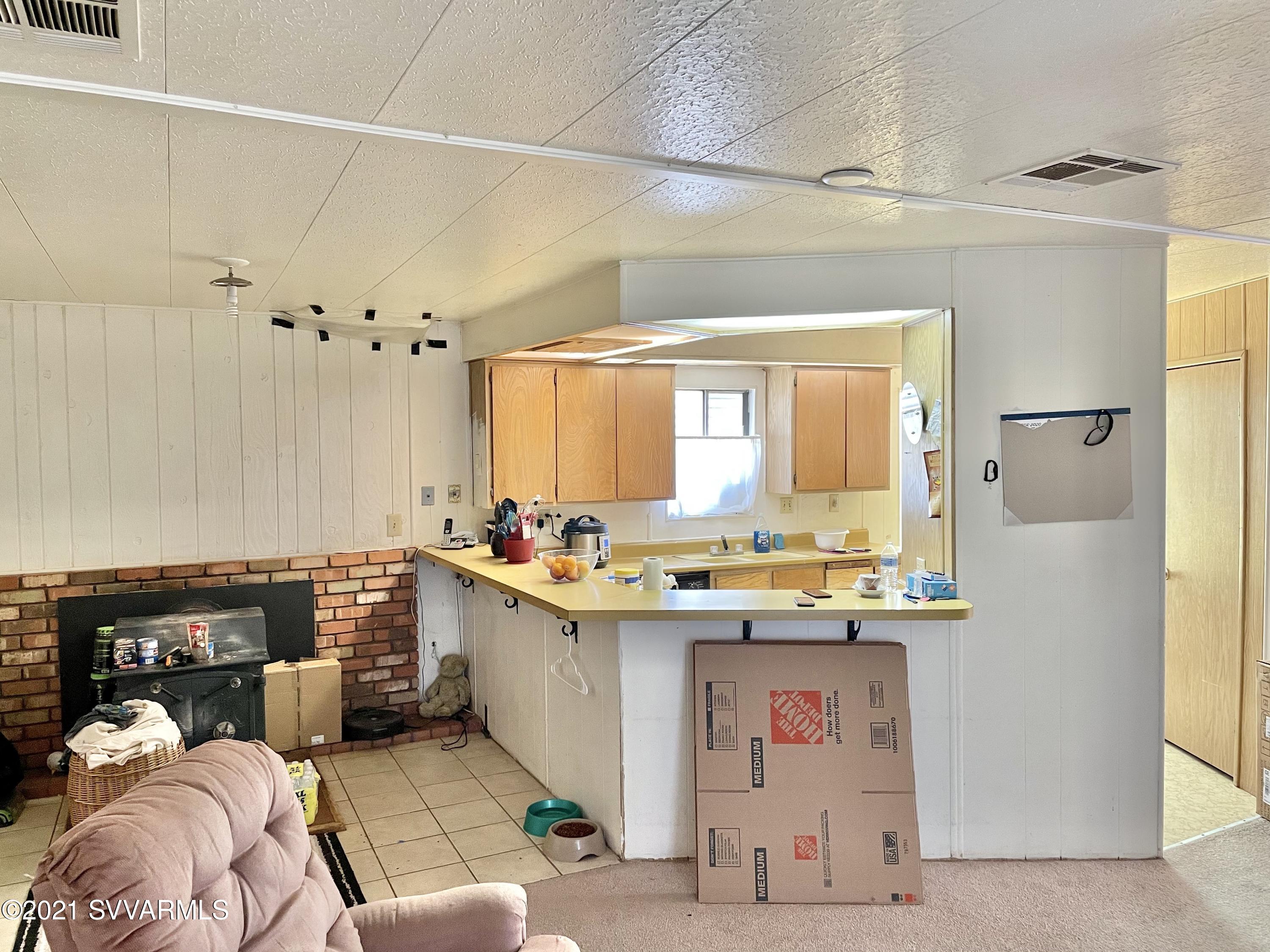 4905 Ho Hum Trail Rimrock, AZ 86335 - Photo 10 of 16 a kitchen with a sink stove and cabinets
