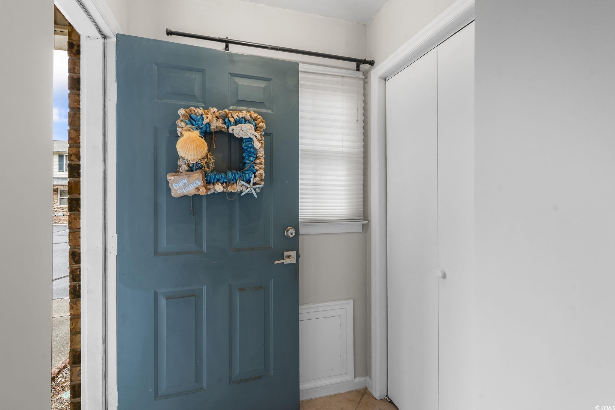 Entrance foyer with light tile patterned floors