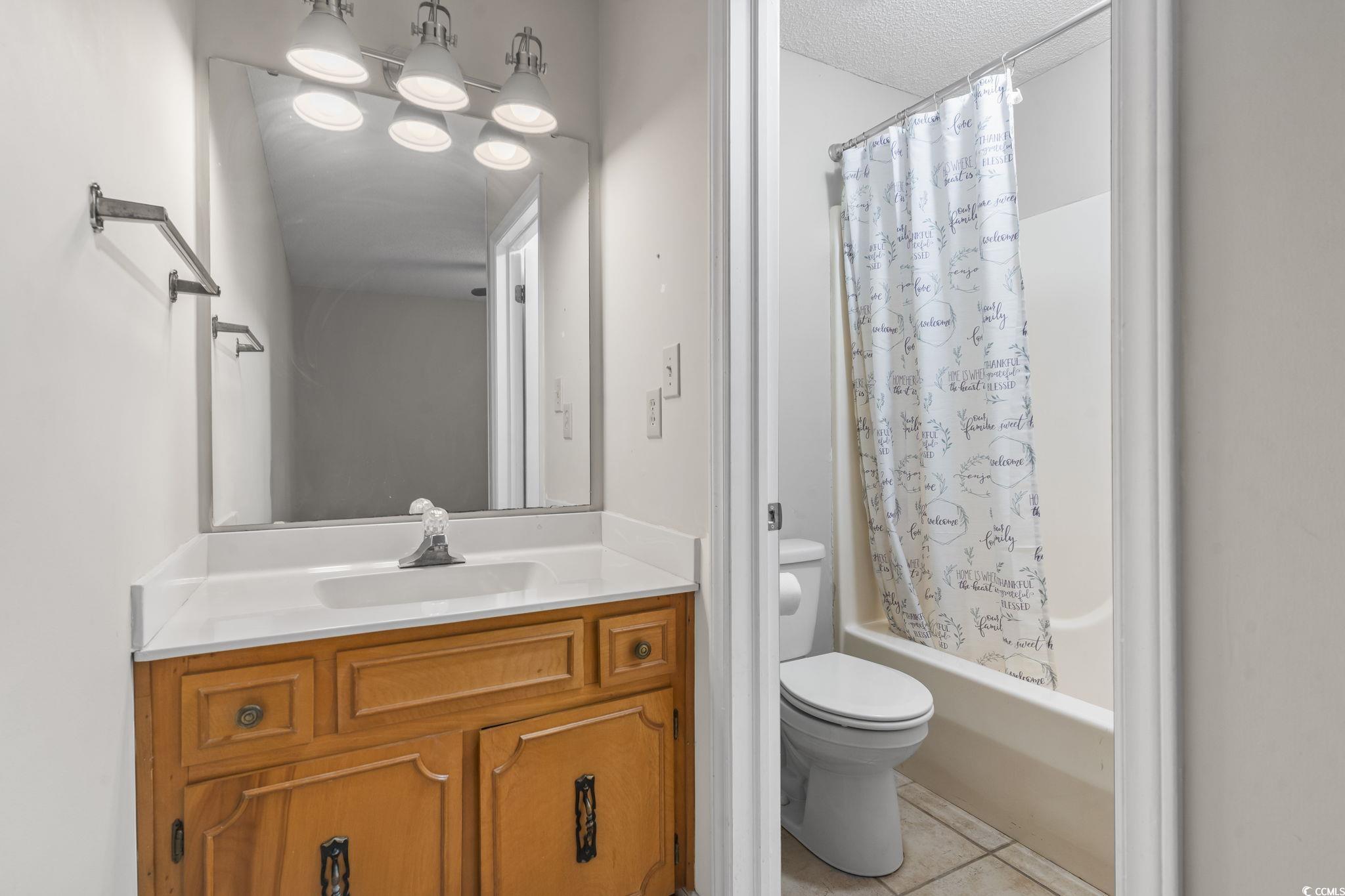 210 25th Avenue South, Unit 13 Myrtle Beach, SC 29577 - Photo 8 of 10 Bathroom featuring shower / tub combo, vanity, and light tile patterned floors