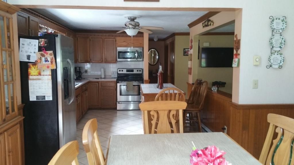 227 Torrey Road Southbridge, MA 01550 - Photo 19 of 30 a living room with stainless steel appliances furniture a rug and a view of kitchen
