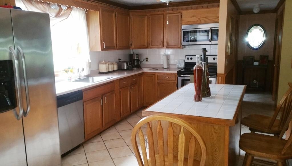 227 Torrey Road Southbridge, MA 01550 - Photo 20 of 30 a kitchen with stainless steel appliances granite countertop a sink refrigerator and microwave