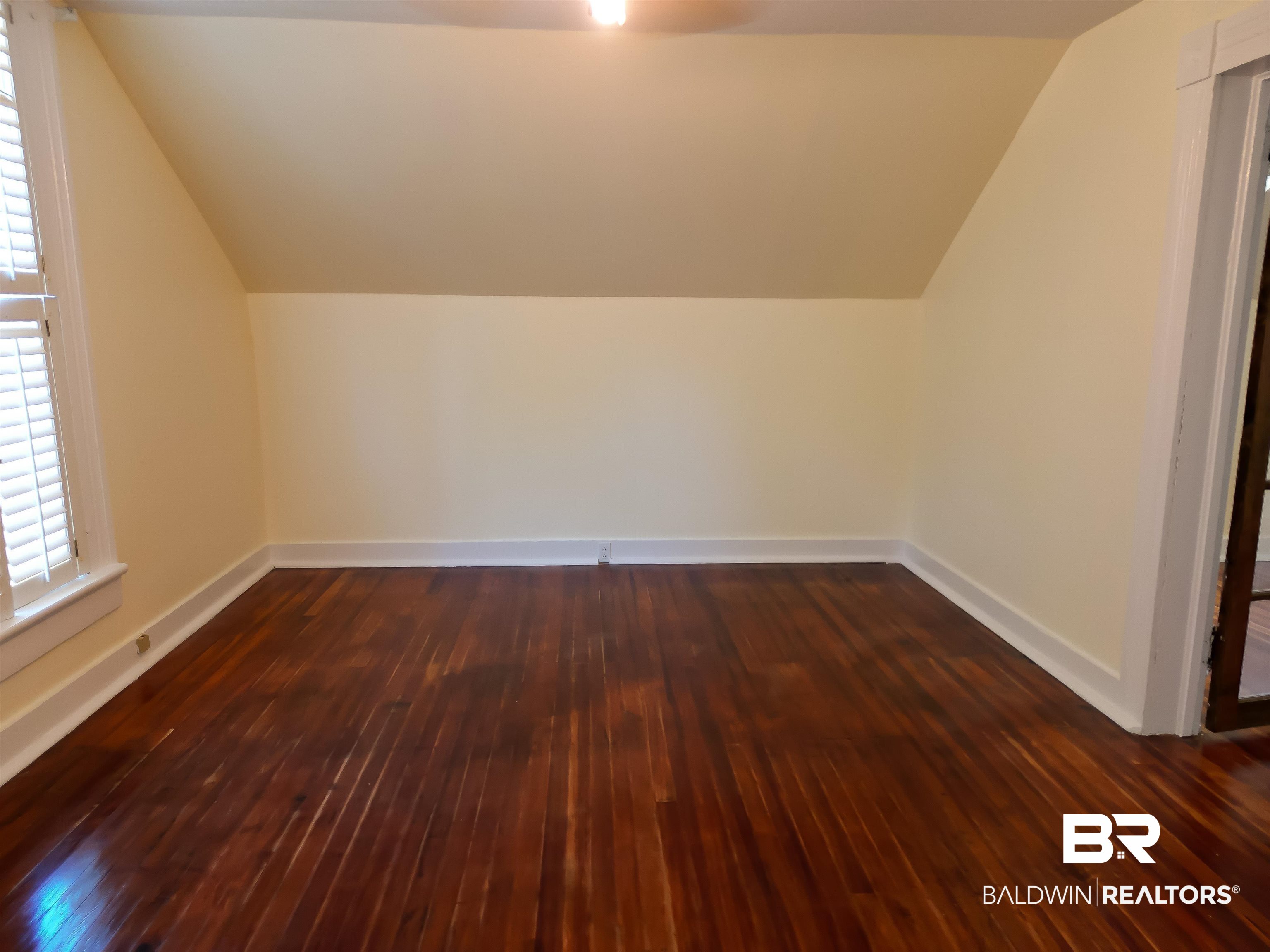73 Liberty Street Monroeville, AL 36460 - Photo 27 of 29 Bonus room featuring dark wood-type flooring and vaulted ceiling