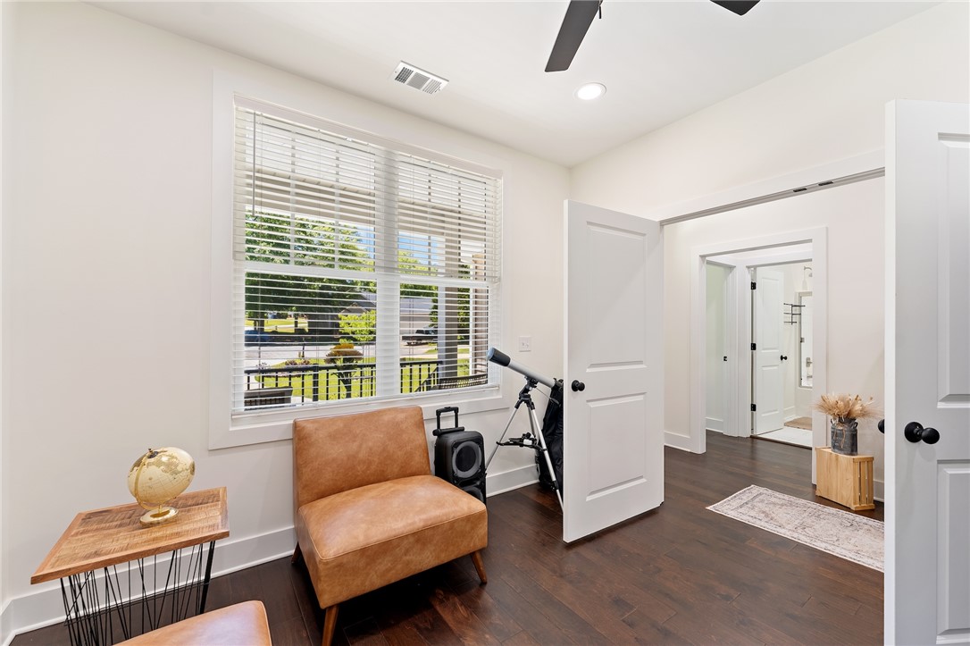 502 Canebrake Drive Anderson, SC 29621 - Photo 25 of 39 This bright room features a large window, dark flooring, and a view into an adjoining bathroom.
