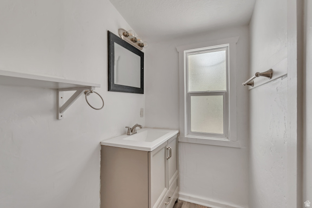 8831 South 400 East Sandy, UT 84070 - Photo 13 of 26 Bathroom with vanity and light wood-style floors