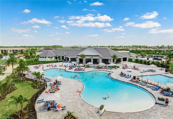 a view of a swimming pool with outdoor seating and city view