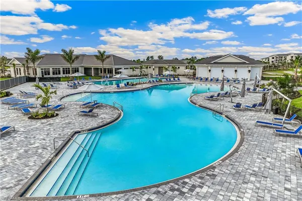 a view of a swimming pool with lawn chairs