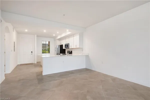 a view of kitchen with stainless steel appliances cabinets