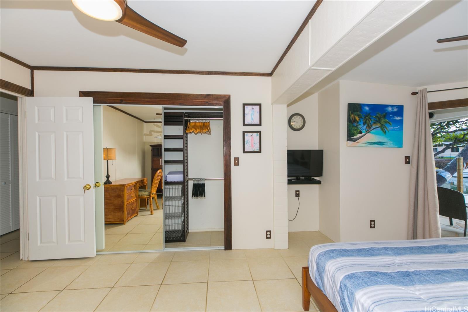 6266 Keōkea Place Honolulu, HI 96825 - Photo 12 of 25 a bedroom with a bed and a mirror
