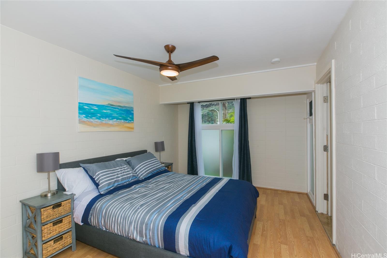 6266 Keōkea Place Honolulu, HI 96825 - Photo 18 of 25 a bedroom with a large bed and a ceiling fan