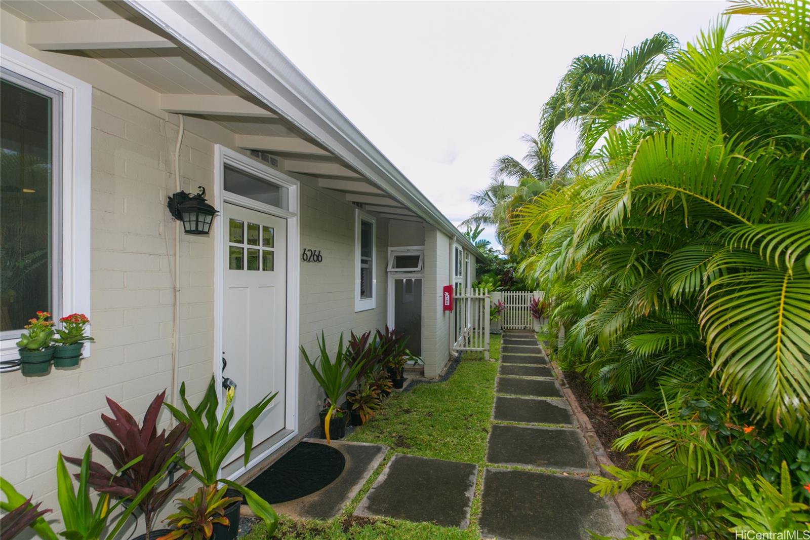 6266 Keōkea Place Honolulu, HI 96825 - Photo 23 of 25 a front view of yellow house with a yard