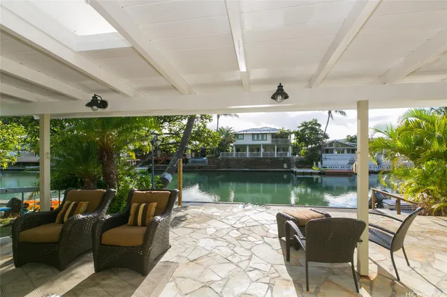 a balcony with furniture and a lake view