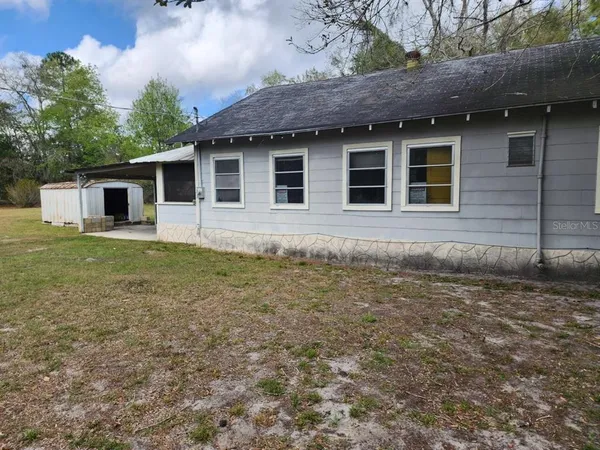 a view of a house with a yard