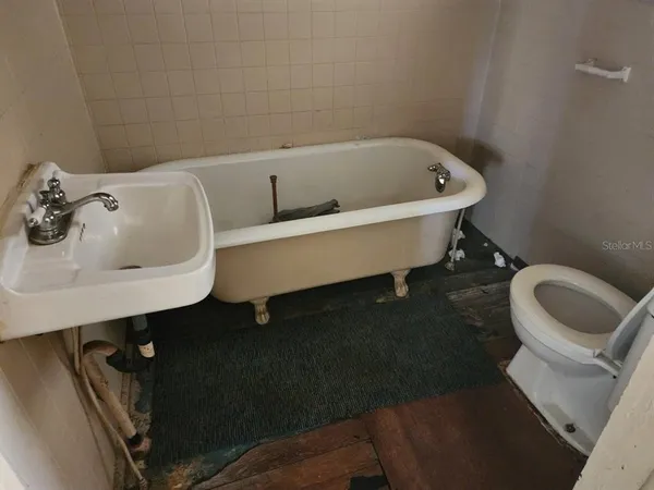 a bathroom with a sink toilet and a bathtub