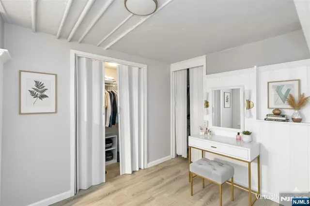 a view of a room with furniture and wooden floor