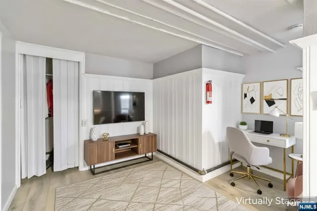 a view of a livingroom with entryway and workspace