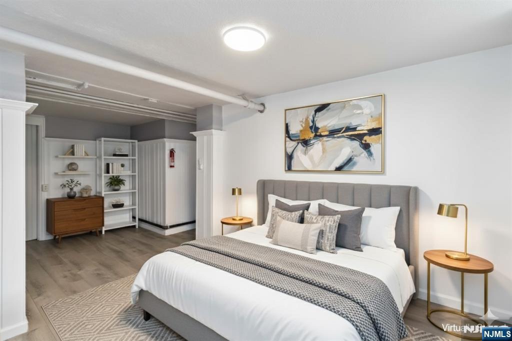 1283 Valley Road, Unit 7 Montclair, NJ 07043 - Photo 17 of 24 a spacious bedroom with a bed and a lamp