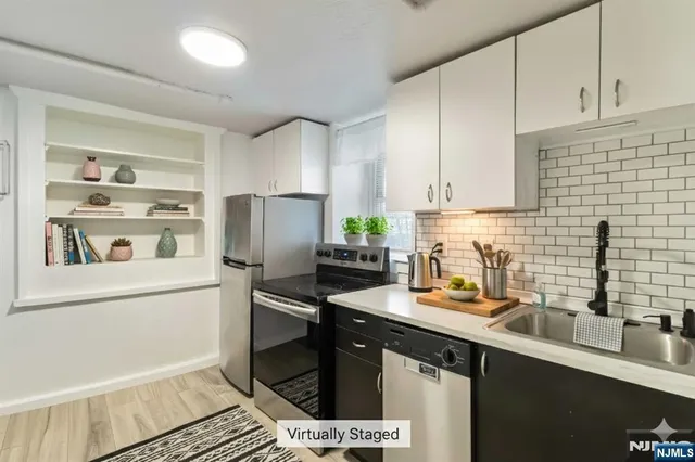 a kitchen with a sink appliances and cabinets