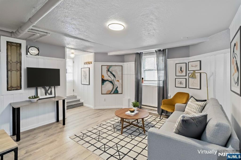 1283 Valley Road, Unit 7 Montclair, NJ 07043 - Photo 8 of 24 a living room with furniture and a flat screen tv