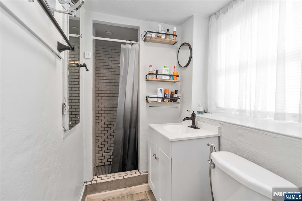 1283 Valley Road, Unit 7 Montclair, NJ 07043 - Photo 9 of 24 a bathroom with a sink toilet and a window