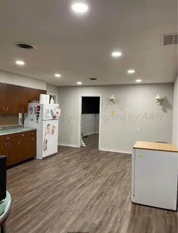 a view of kitchen with a sink and wooden floor