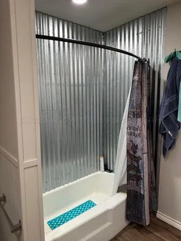 a bathroom with bathtub and shower