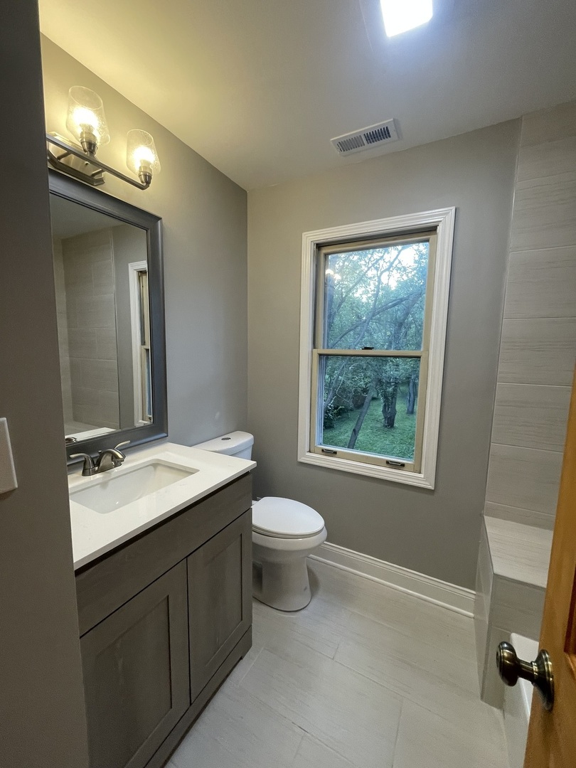 3-s284 Pattermann Road Warrenville, IL 60555 - Photo 15 of 21 a bathroom with a toilet sink and mirror