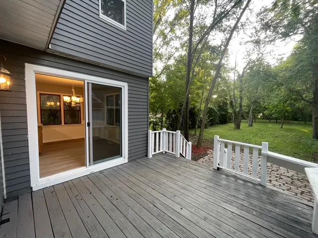 a view of a deck with chairs and a yard