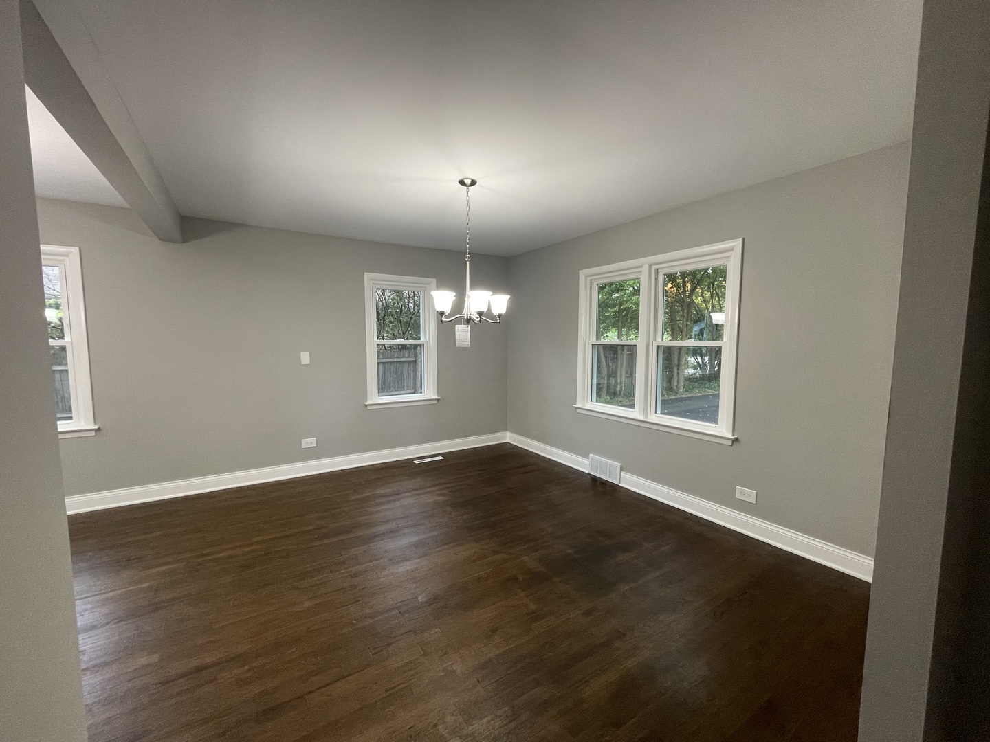 3-s284 Pattermann Road Warrenville, IL 60555 - Photo 5 of 21 an empty room with wooden floor and windows
