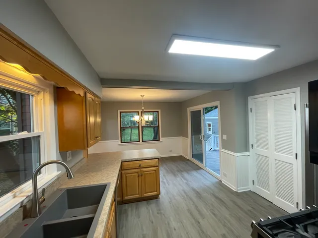 a view of a livingroom with wooden floor and furniture