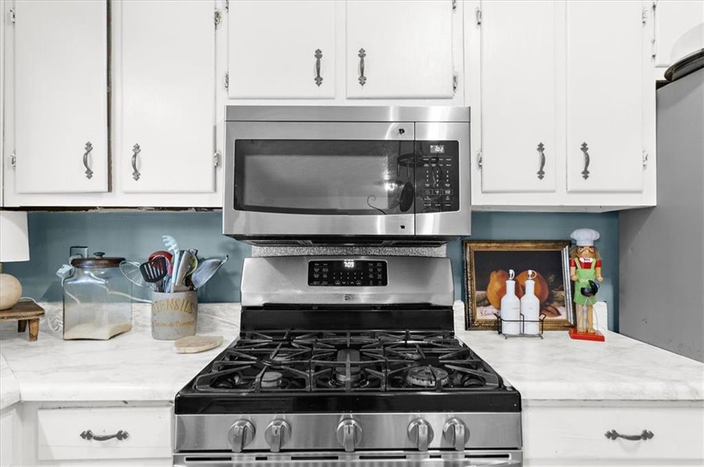 1059 Old Alabama Road Southwest Mableton, GA 30126 - Photo 11 of 33 a stove top oven sitting inside of a kitchen and white cabinets