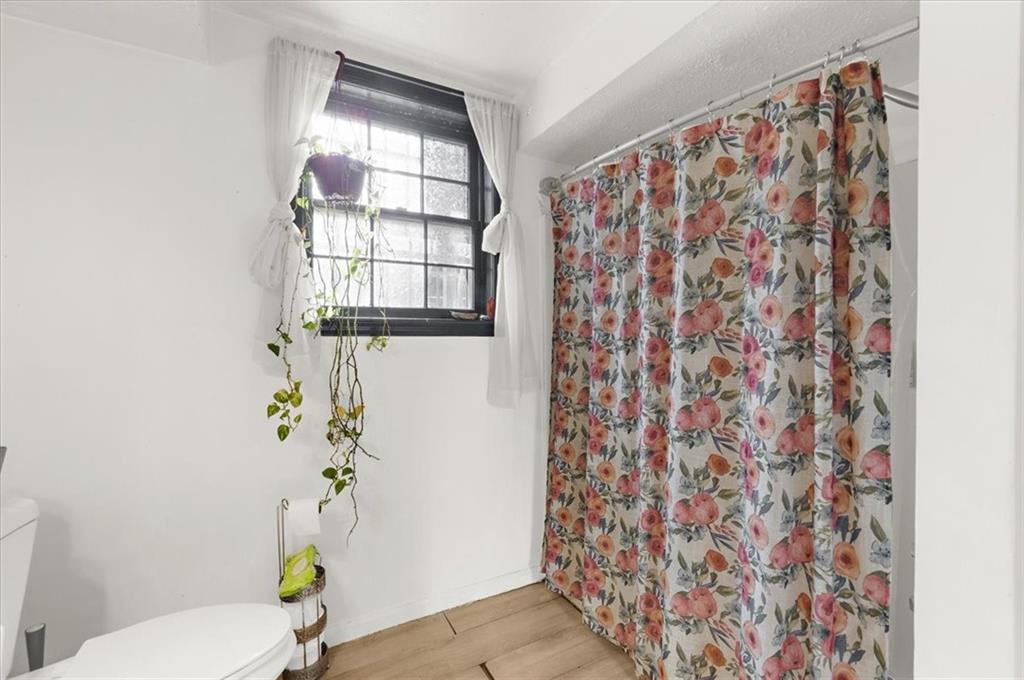 1059 Old Alabama Road Southwest Mableton, GA 30126 - Photo 25 of 33 a bathroom with a toilet and a shower curtain