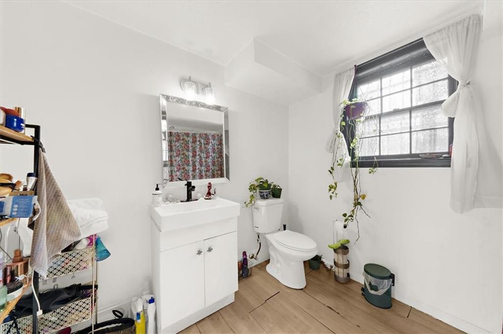 1059 Old Alabama Road Southwest Mableton, GA 30126 - Photo 26 of 33 a bathroom with a sink mirror toilet and window