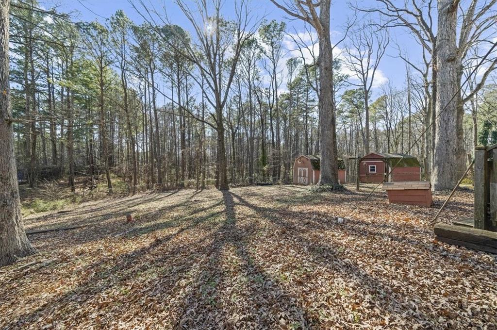 1059 Old Alabama Road Southwest Mableton, GA 30126 - Photo 31 of 33 a backyard of a house with trees and outdoor space